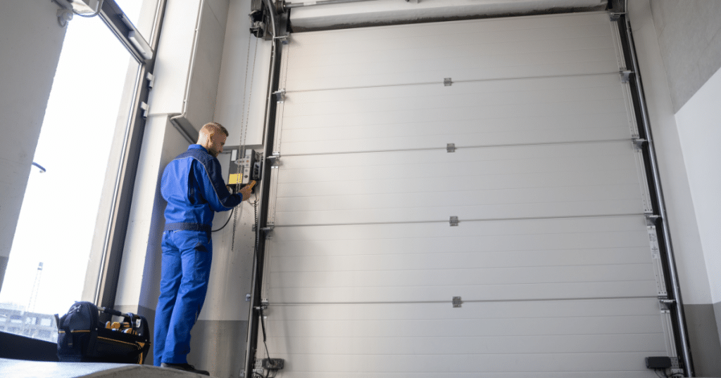 Technician operates tall garage door system.