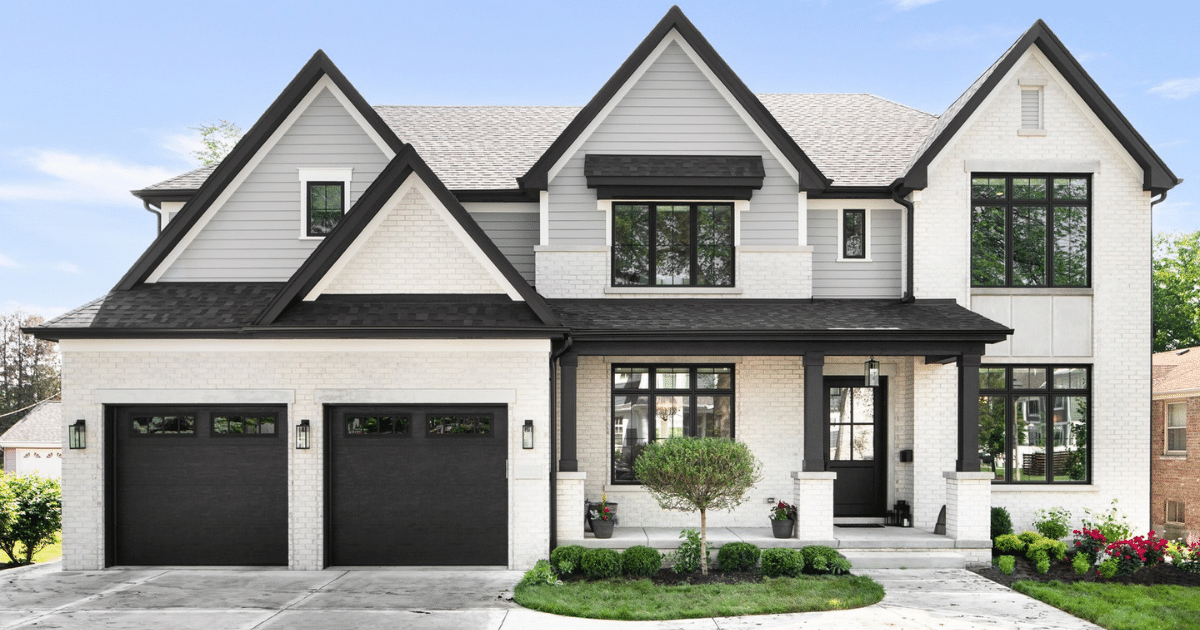 white house with black garage doors